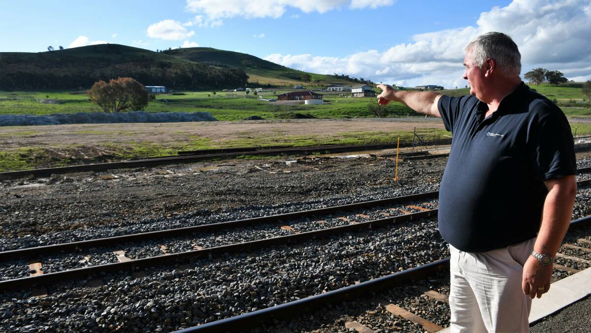 QUESTIONS: Tarago Progress Association president Wayne Baynham points out the contamination area at the railway station. Photo: Hannah Neale