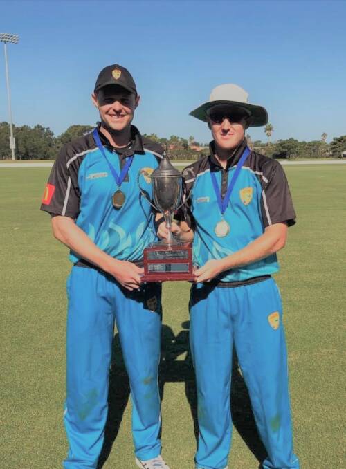 Winners: GDCA's Brad Smith (left) and Josh Watling are all smiles as they hoist the Country Championships trophy after their grand final win over Central Coast. Photo: Supplied.