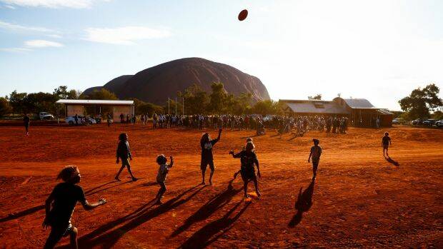 'It is a sad state of affairs that the voice of our first Australians is ignored.' Pictured are children of the Mutitjulu community playing football. Photo: Alex Ellinghausen