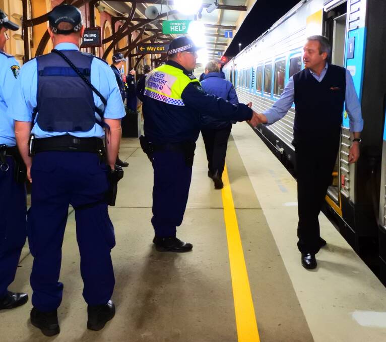 OPERATION DISRUPT: Sergeant Michael Chubb (centre) thanks personnel on one of the night trains. Photos: Ainsleigh Sheridan