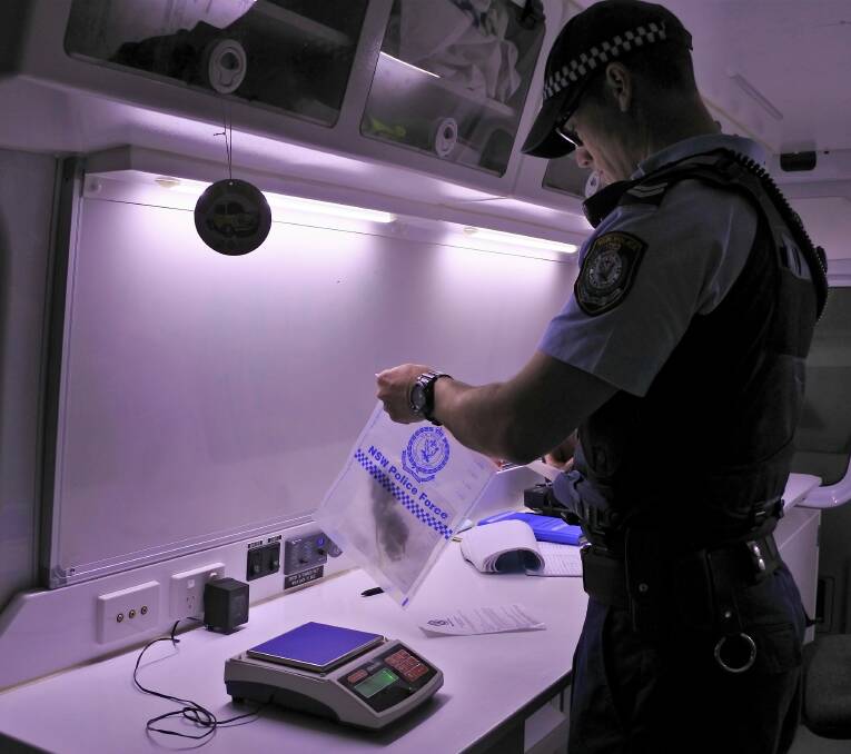 MOBILE UNIT: Found drugs are taken to a laboratory van to be weighed, verified and bagged as evidence.