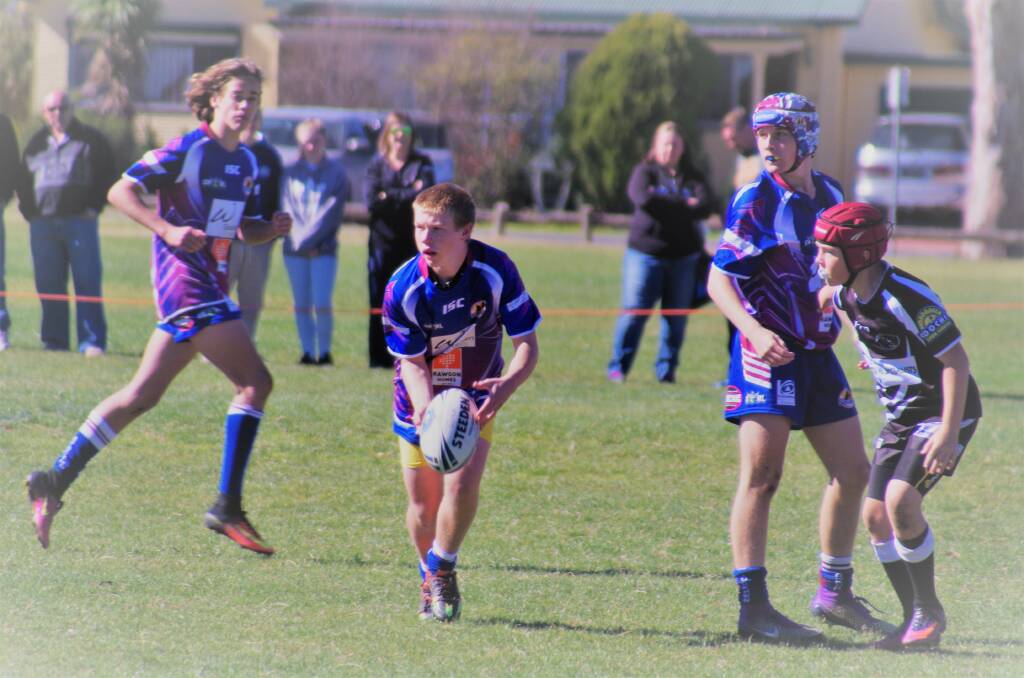 TEAMWORK: Trent Price (centre) looks to get a pass to one of his teammatesduring the under 14s game against Yass, at North Park on May 7. Photo: Darryl Fernance