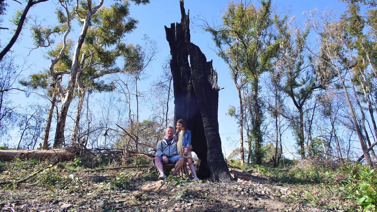 Jim Hughes and his daughter Raeden survey the wreckage of their property. Picture supplied.