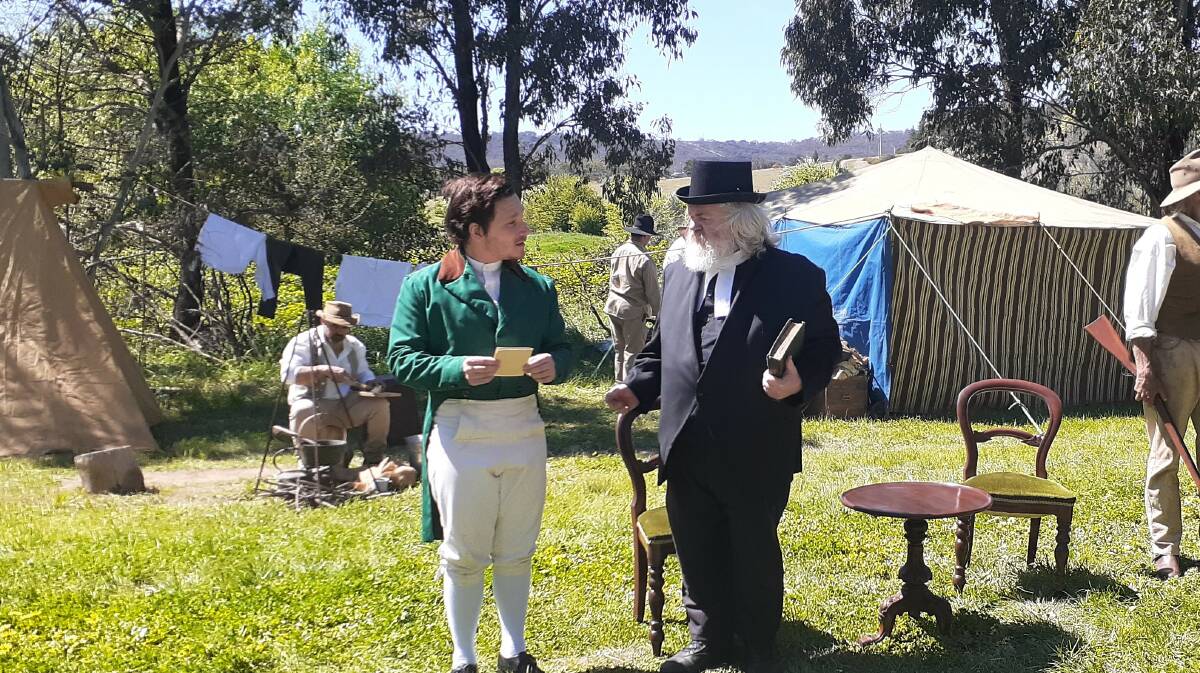 Macquarie's valet George Jarvis (Blake Selmes) talks to Reverend Cartwright (Brian Hill), while Josh Wild (Martin Sanders) stands by. In the background is Macquarie's camp at Bundong (Lake Bathurst). Picture: Jennifer Lamb.