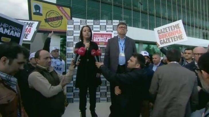 Sevgi Akarcesme (left), editor of <i>Today's Zaman</i>, addresses a rally after the government takeover of the newspaper.