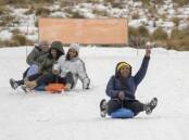 Visitors enjoy the snow at the Afriski ski resort near Butha-Buthe, Lesotho. (AP PHOTO)