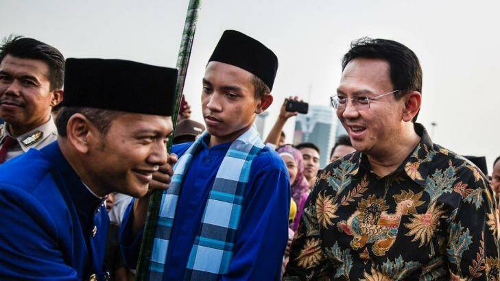 Ahok, right, greets people after arriving at the National Monument in Jakarta in 2014. A Christian and ethnic Chinese, he became governor after his predecessor and political ally Joko Widodo was elected president of Indonesia. Photo: New York Times