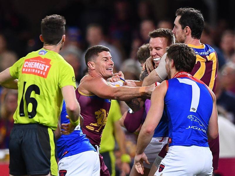 Brisbane's Dayne Zorko (l) gets into a scuffle during the AFL hammering by the Demons at the Gabba. (Jono Searle/AAP PHOTOS)