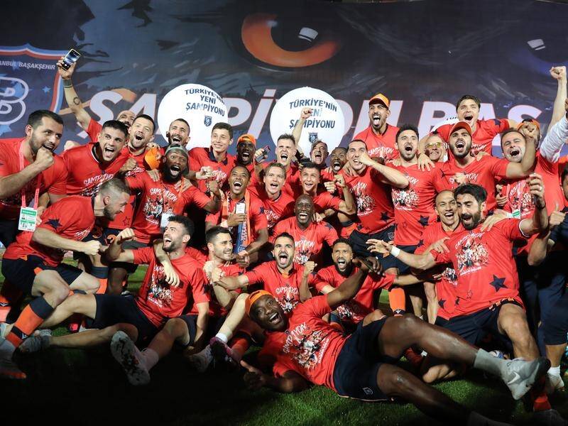 Istanbul Basaksehir's players, including Socceroo Aziz Behich, celebrate their Turkish title win.