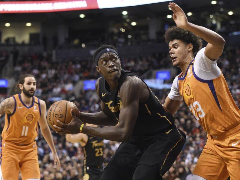 Raptors forward Pascal Siakam (C) on his way to scoring 37 points against the Suns.