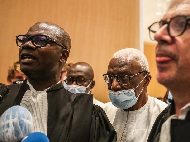 Lamine Diack (C) has been jailed for two years by a French court for corruption.