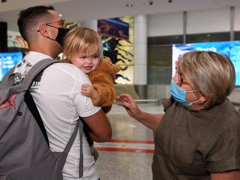 Families were reunited as planes flew into Sydney from overseas nearly 600 days after borders shut.