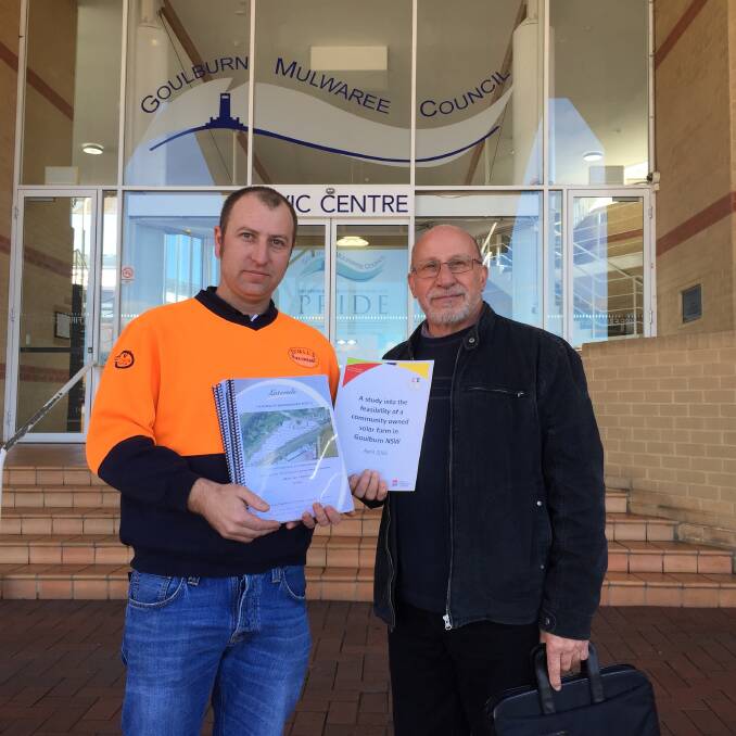 LODGED: Community Energy For Goulburn's Caleb Fisher and Nestor Ellinopoullos with the Goulburn Solar Farm DA at the council on Monday. Photo: David Cole