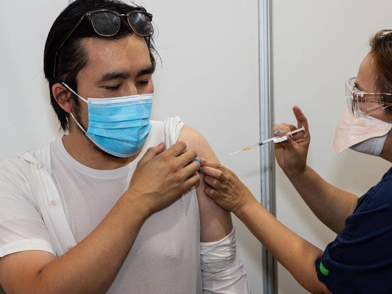 Doctors urge Australians to get their vaccinations up to date for both COVID-19 and the flu. (Diego Fedele/AAP PHOTOS)