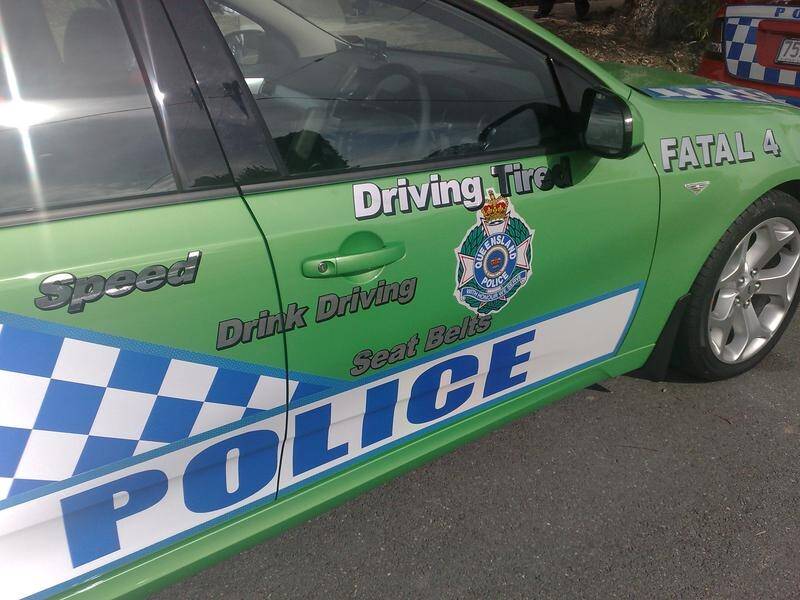 Queensland police raided properties after racist graffiti and banners were found in a Brisbane park.