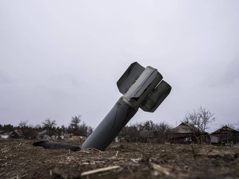 The tail of a missile sticks out in a residential area in Yahidne, near Dnipro in central Ukraine.