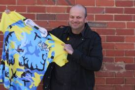 Stags committee member Craig Norris with the special one off jumper to be worn by Stags players in the "Call to Arms" round this weekend.