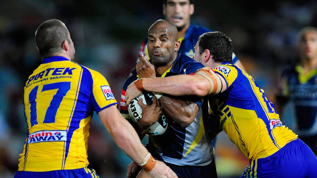 Former Cowboys and Sea Eagles player Michael Bani is tackled by Justin Poore and Nathan Cayless of the Eels at Dairy Farmers Stadium, Townsville in April, 2010 | Photo by Ian Hitchcock, Getty Images.