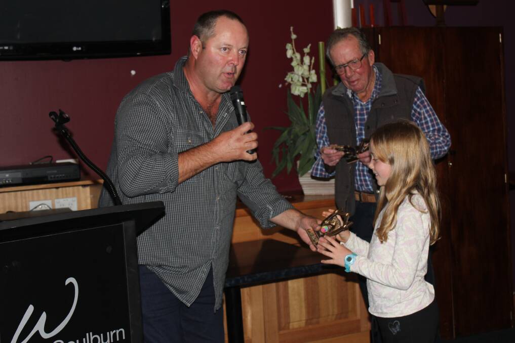 YOUNGEST: The club’s junior rider and youngest member, 8 year old Skye Gilpin accepts her award from Rideathon Director Craig Young.