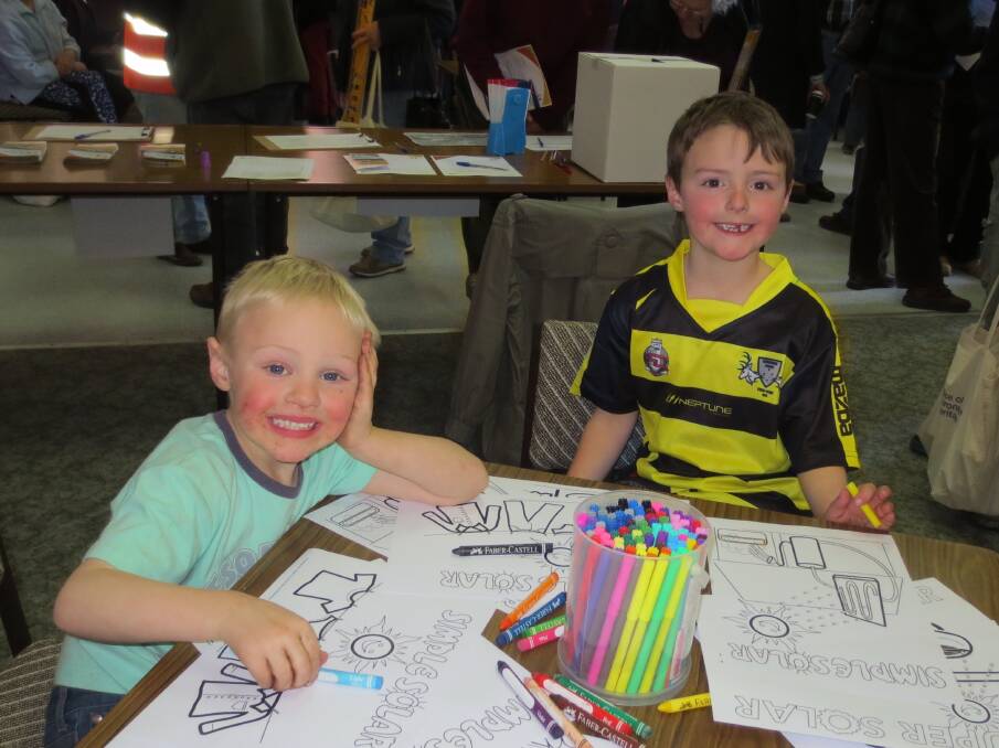 ADDING COLOUR: Maton and McKenzie Brown, who attended with their parents, helping add colour to some renewable energy posters.