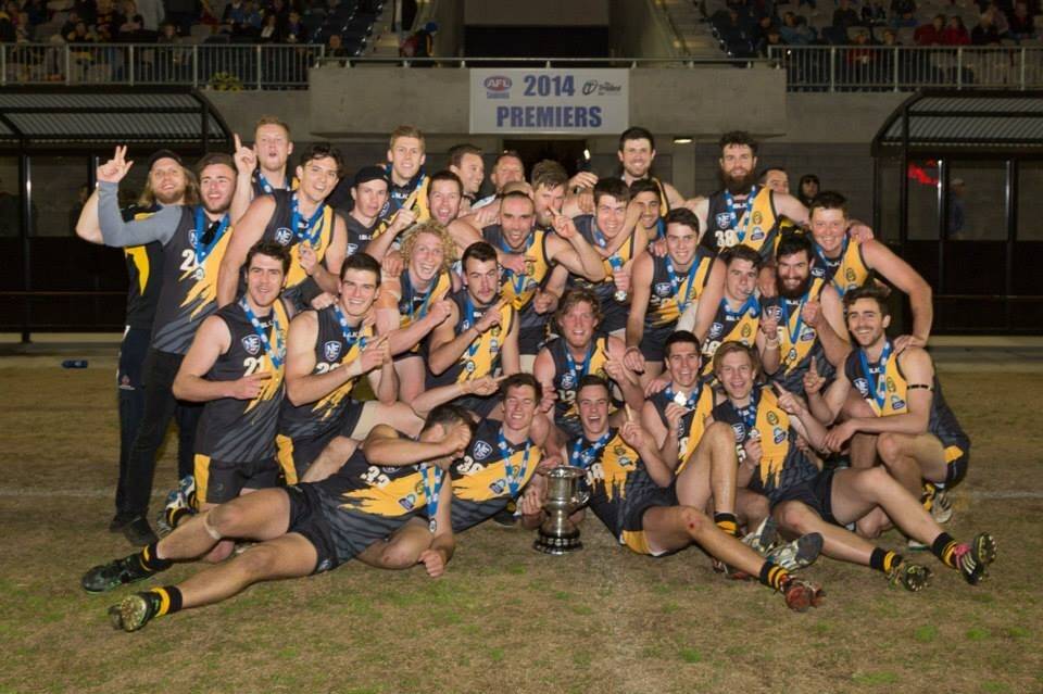 The Queanbeyan Tigers' AFL Canberra division one side celebrates after their premiership win over Ainslie last Saturday night. Photo: Ben Southall.