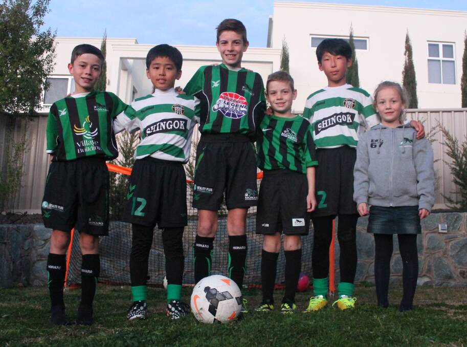 Monaro's Skazlic family kids, left to right, Sam, Daniel, Jake, and Lilly, with SinGok Korean players, left to right, Tae Young Shin and Chang Seon Oh. Photo: Joshua Matic.