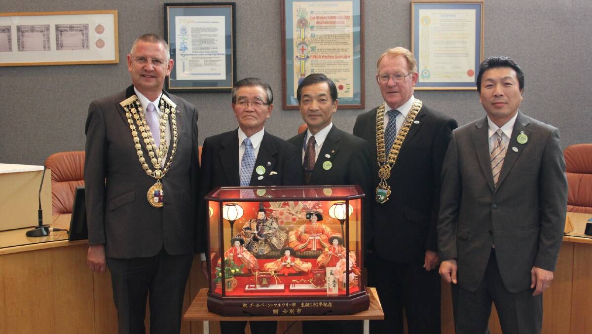 CATCHING UP: Mayor Geoff Kettle, Former Mayor of Shibetsu City Council Takariko Susumu, Shibetsu Chamber of Commerce President Chiba Michio, Goulburn Mulware Deputy Mayor Bob Kirk and Shibetsu City Council City Official Higashikawa Akihiro when a delegation visited Goulburn for its 150th birthday last year and presented the Council with this gift of a traditional music box.