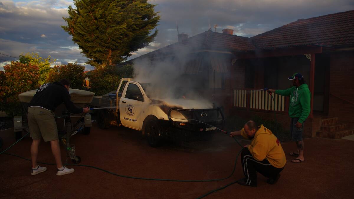 Neighbours were quickly on the scene of a car fire in Chisholm St on Sunday night. Photo: Darryl Fernance.