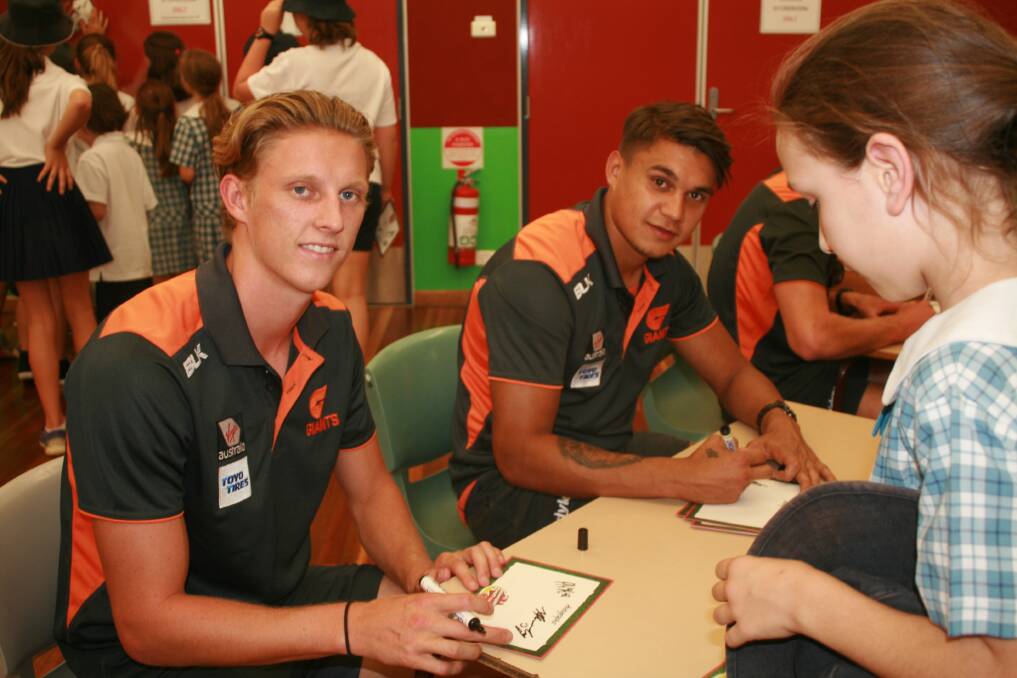 Lachie Whitfield and Jarrod Pickett of the GWS Giants signed autographs for Queanbeyan and Jerrabomberra students during school visits. Photo: Gemma Varcoe. 