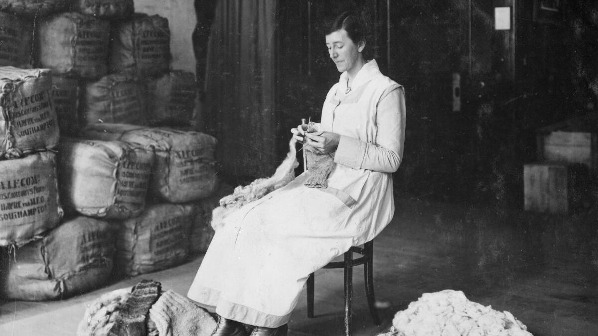 HOME FRONT: An Australian Comforts Fund photograph of a Miss Coll knitting socks direct from a sheep’s fleece. PHOTO: AWM H02438    