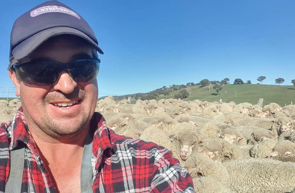 Southern Tablelands Flock Ewe Champion Daniel Fitzell with a mob of sheep at Flowerburn, Peelwood. Photo: supplied