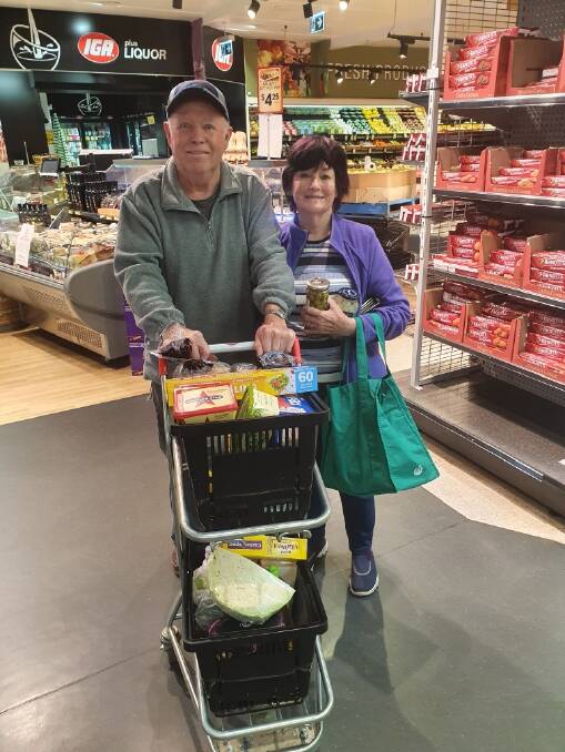 Les and Barb Steain stock up on essential items during Crookwell IGA's elderly hour. Photo: supplied