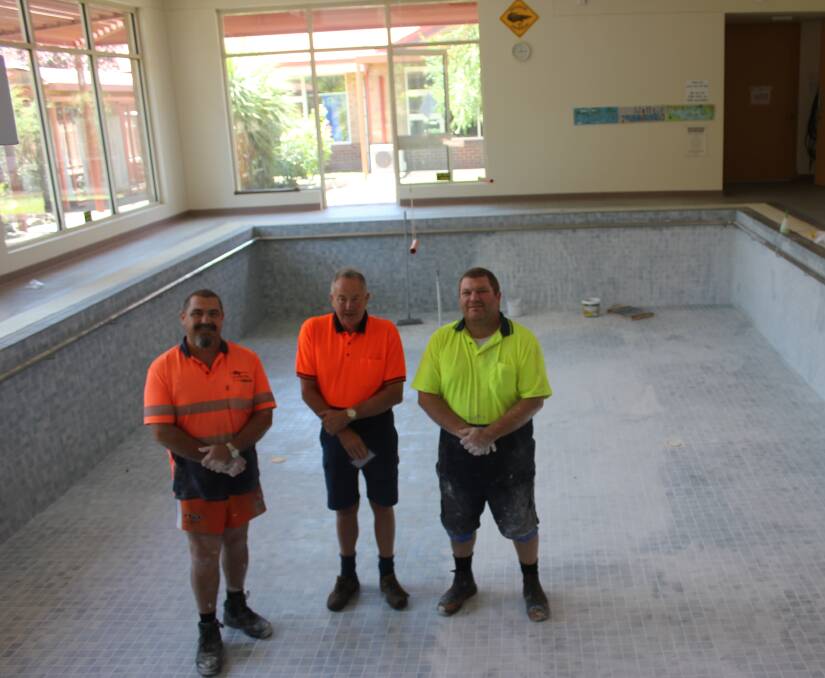 Pool maintenance workers from HydoThermae Michael Read and Mark Read with Bourke Street Health service asset manager Dooley Hazelgrove. Photo Burney Wong.