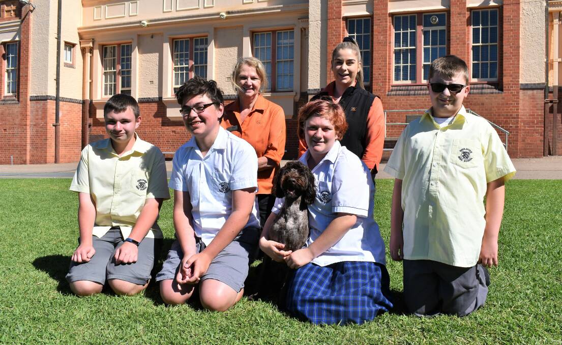 Goulburn Soldiers Club functions coordinator Kerri Taylor and Goulburn Soldiers Club promotions and loyalty coordinator Emma McColl with Goulburn High School Students and support dog Alice. Photo: Lauren Strode. 