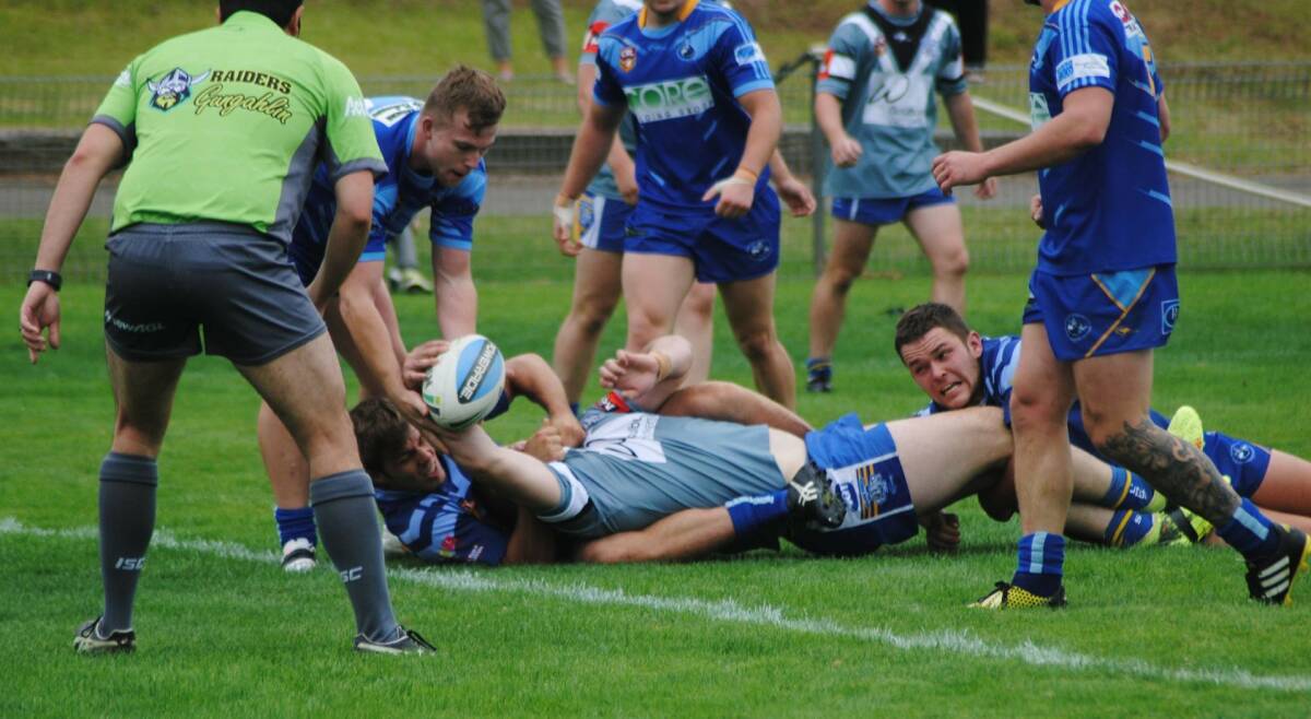 CLOSE: The Workers Bulldogs being held up while attempting to reach for the try line. Photo: Burney Wong.  