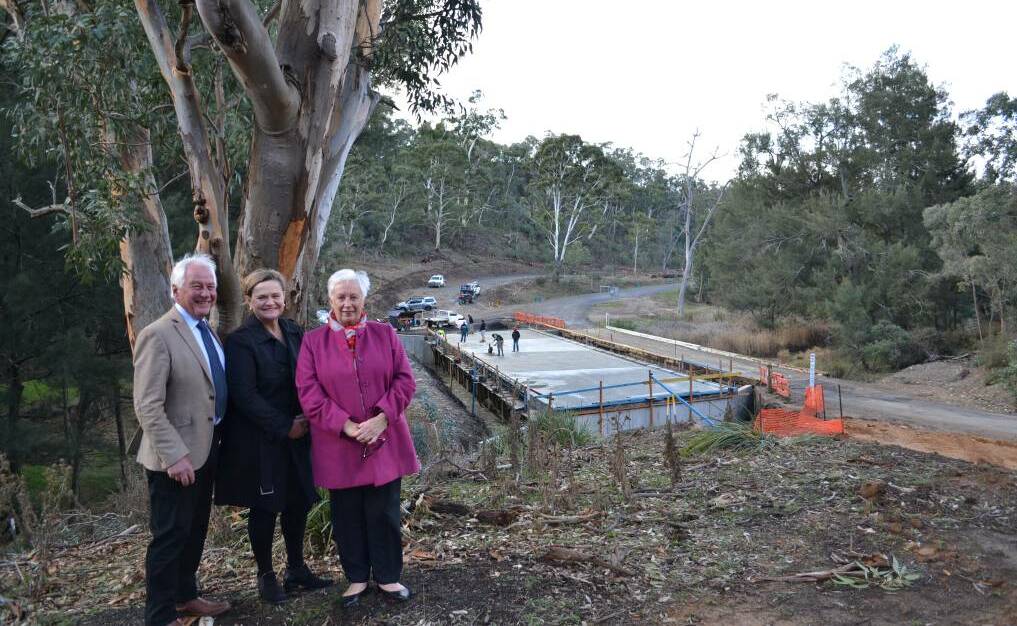 Now complete: Upper Lachlan Shire Council Mayor John Stafford, member for Goulburn Wendy Tuckerman and mayor of Oberon Council Kathy Sajowitz back when the bridge was under construction. Photo: supplied. 