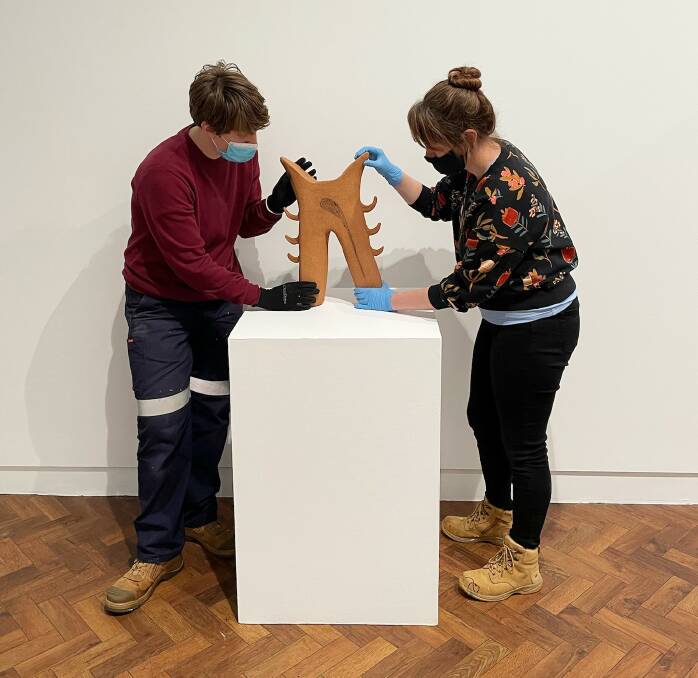 Exhibition and program coordinator Hannah Gee and education officer Sally O'Neill setting up. Photo: Goulburn Regional Art Gallery. 