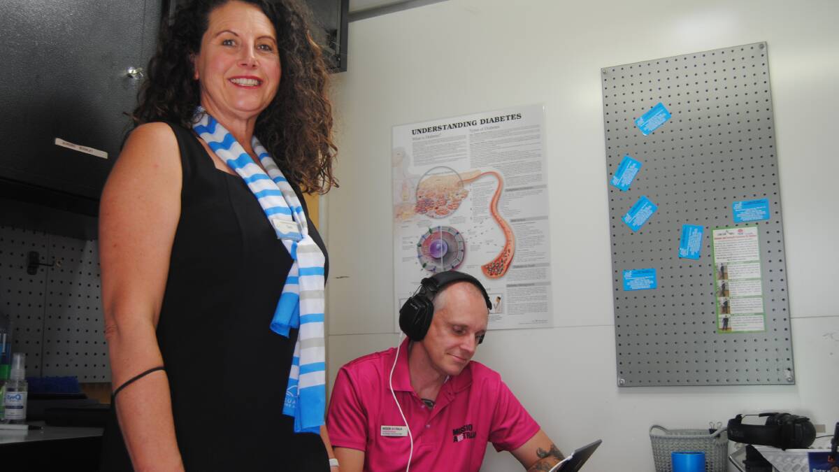 Mission Australia's area manager of south eastern NSW and ACT Daniel Strickland doing a hearing test conducted by mobile screening officer Tania Shipton. Photo: Burney Wong. 