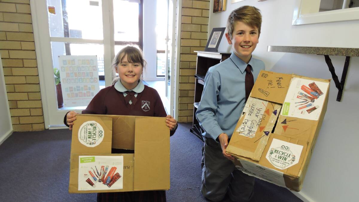 Ss Peter and Paul's students Mia (Year 4) and Lachlan (Year 6) show boxes ready and waiting for donations of your used toothpaste tubes and caps, floss containers and toothbrushes before October 31. Photo supplied