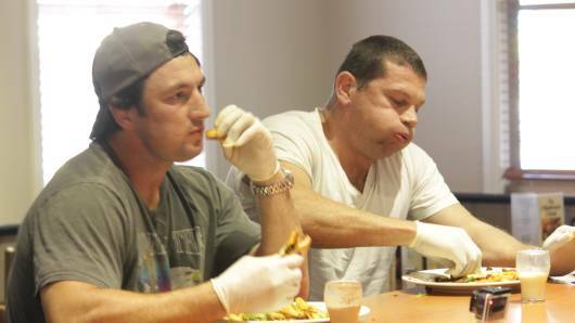 Bryan Fletcher and Nathan Hindmarsh trying out the Hibo Burger Challenge at the Hibernian Hotel back in 2014. Picture by Chris Clarke. 