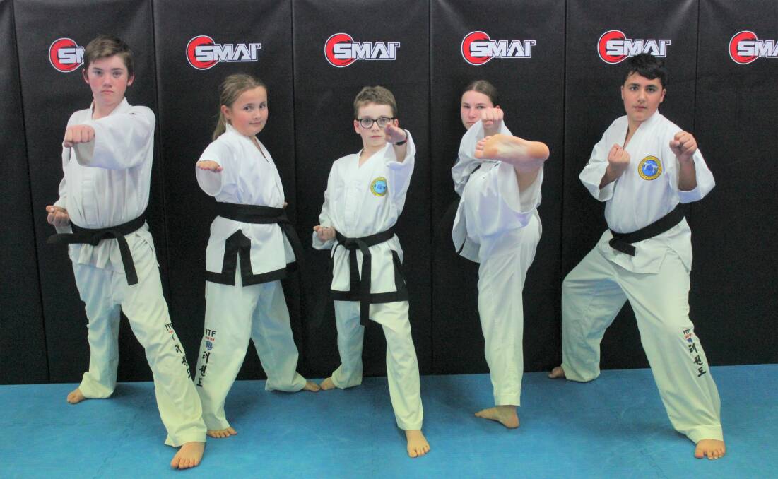 Jordon Woods, Casey Roberts, Isaac Edwards, Merrin Eagles and Kye Davis all received their first degree black belts. Photos: Burney Wong. 