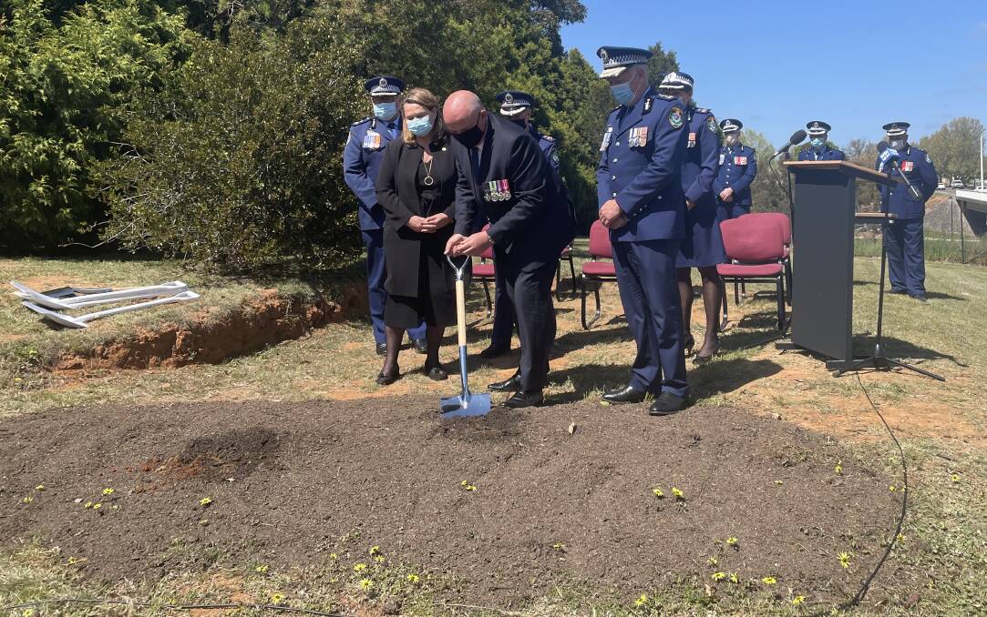Dig: Minister for Police and Emergency Services David Elliott turns over the first sod at the location of the new Goulburn Police Station. Photo: Burney Wong. 