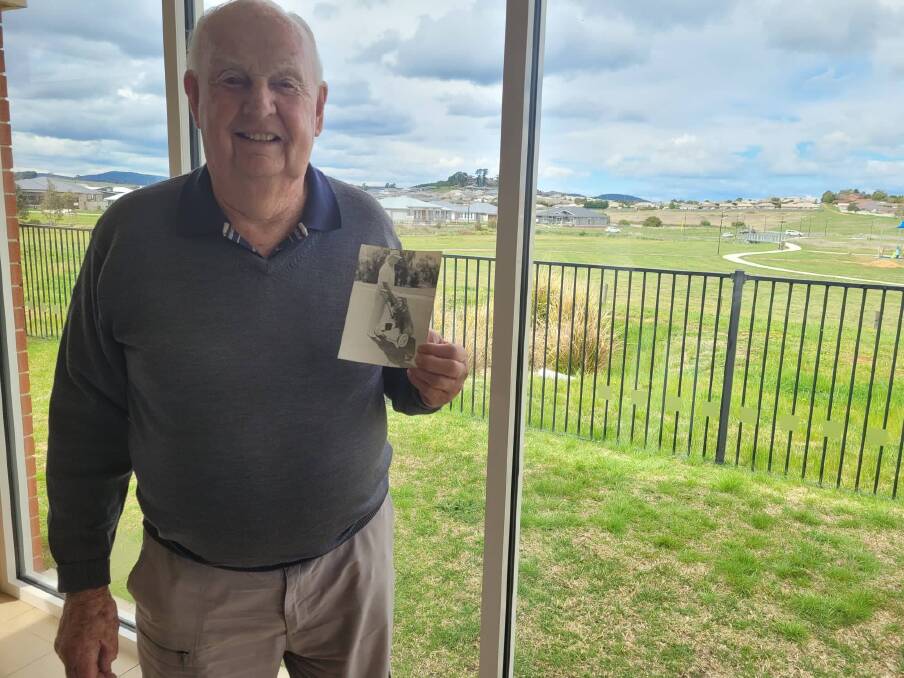 John Bowen with a photo of him playing golf. 