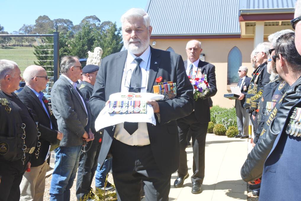 Platoon Commander Dave Sabban carrying the medals at the funeral of Walter (Wally) Raymond Buckland. Photo: Neha Attre