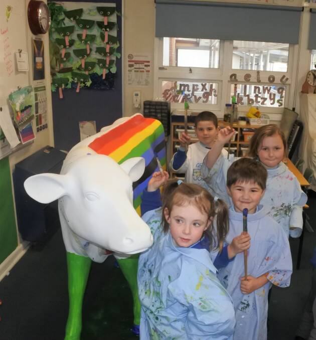 YOUNG PICASSOS: The students of Goulburn North Primary School are painting the fibreglass cow as part of 'Picasso Cow' program which is an initiative of Dairy Australia. Photo: Neha Attre