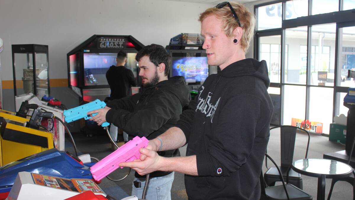 Jeremy Burke and Will Billington playing one of the shooting games. File pic