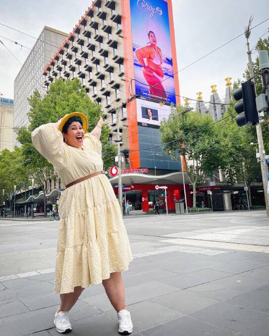 April Hélène-Horton standing in front of the billboard in Melbourne. Pic: Supplied 