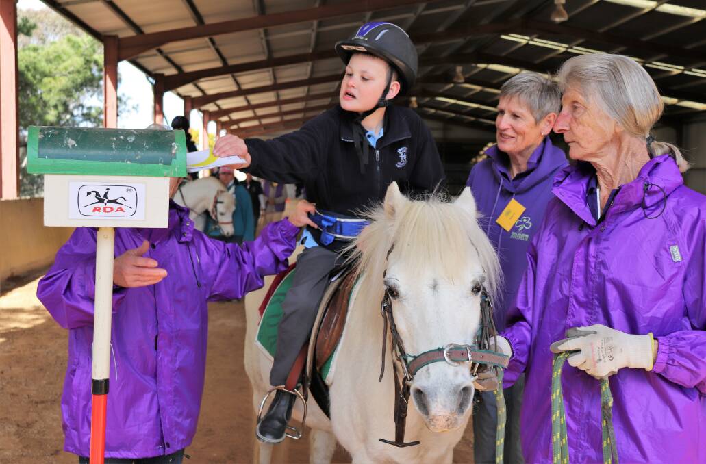 Rider Evan Upton with volunteers Monika Augustin, Roslyn Slater and Aileen Rigby. Photo: Supplied