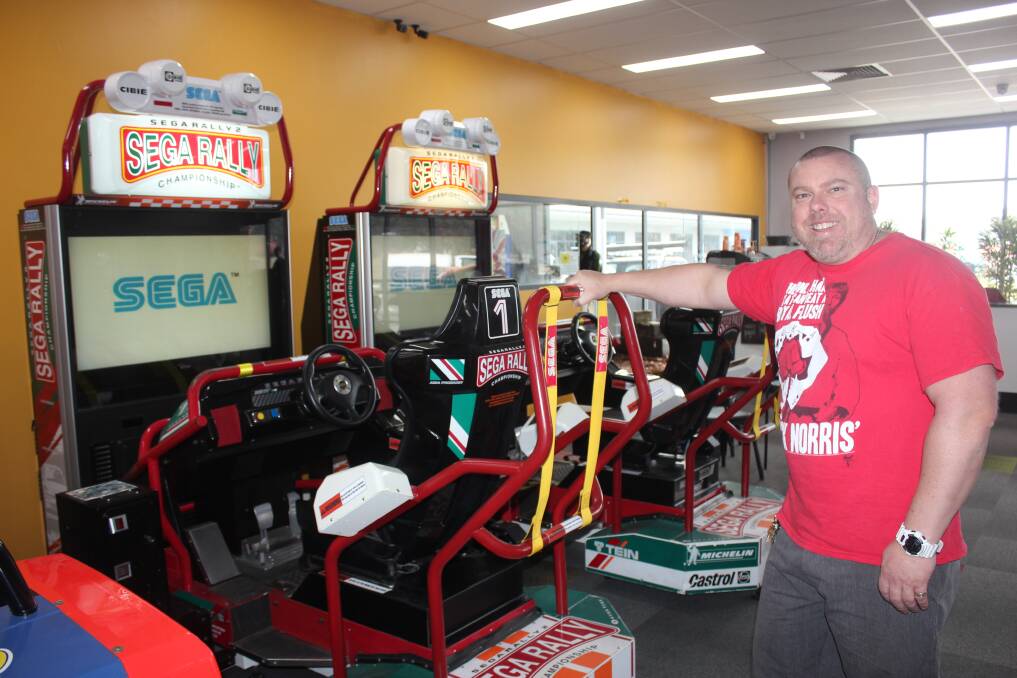 Greg Appleton with some of the Sega Rally racing car games he has up at Back To The Arcade. Photo David Cole. 