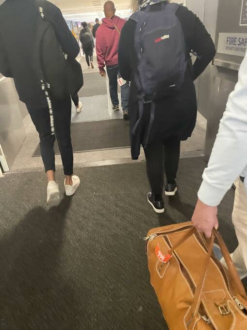 Passengers walk over special sanitiser mats at Sydney airport after arriving from Bali. Picture: Donna Page